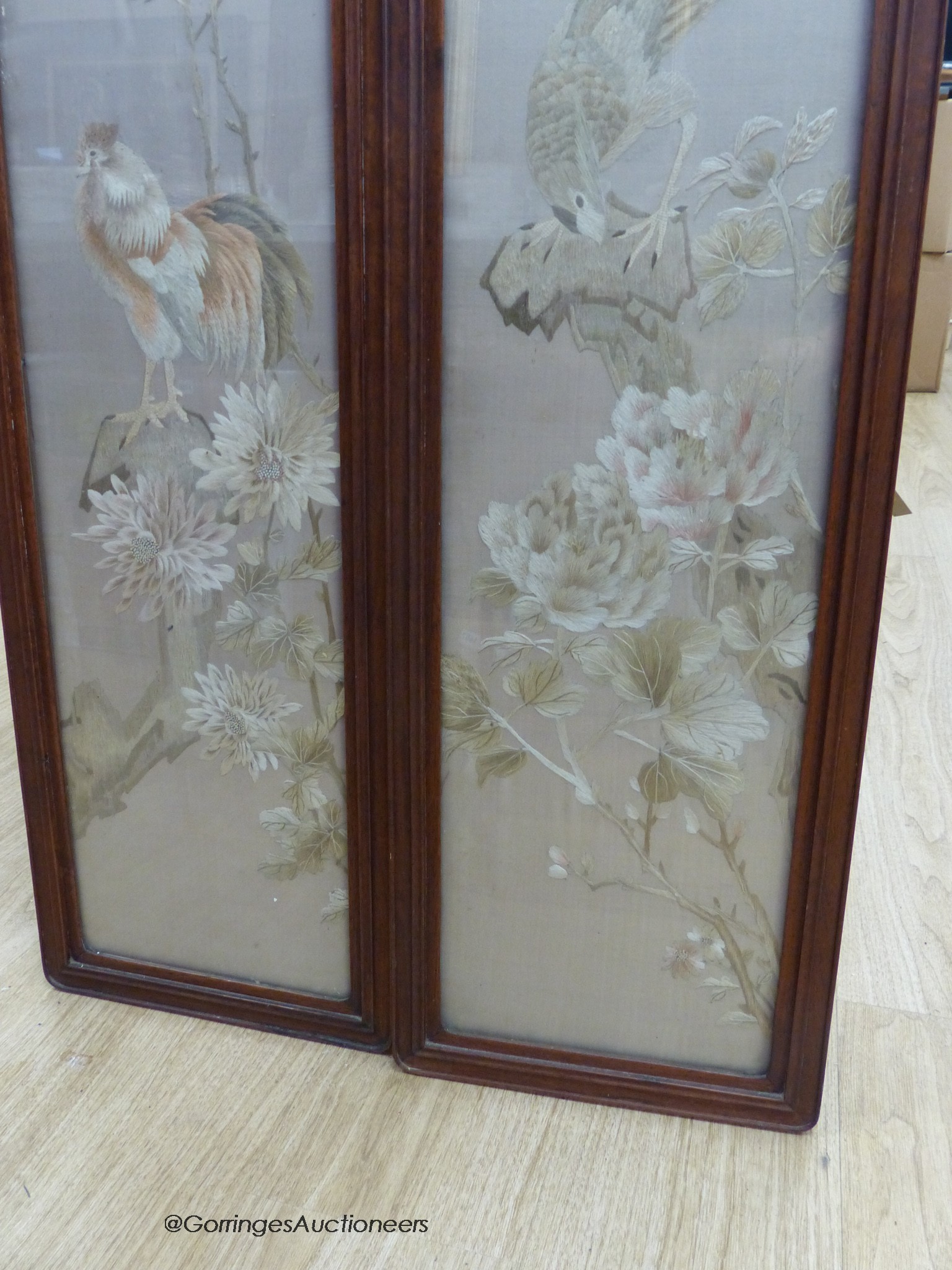 A pair of late 19th century Chinese embroidered silk pictures, in hongmu frames, 111 cm x 29 cm in total